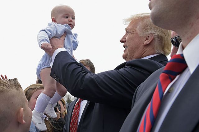 President Trump picks up a baby in Milwaukee in 2018